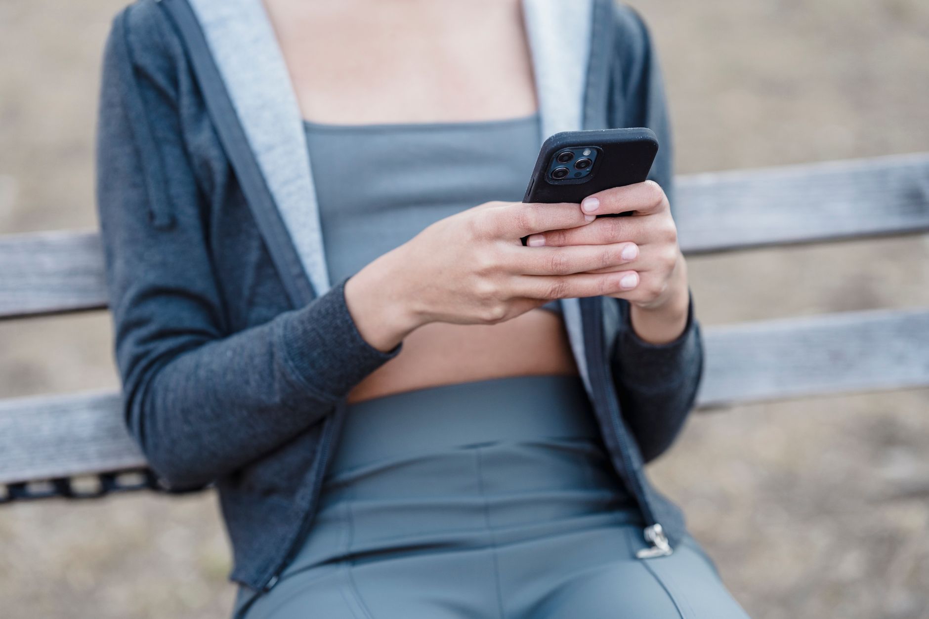 Young woman scrolling through social media on her phone at home