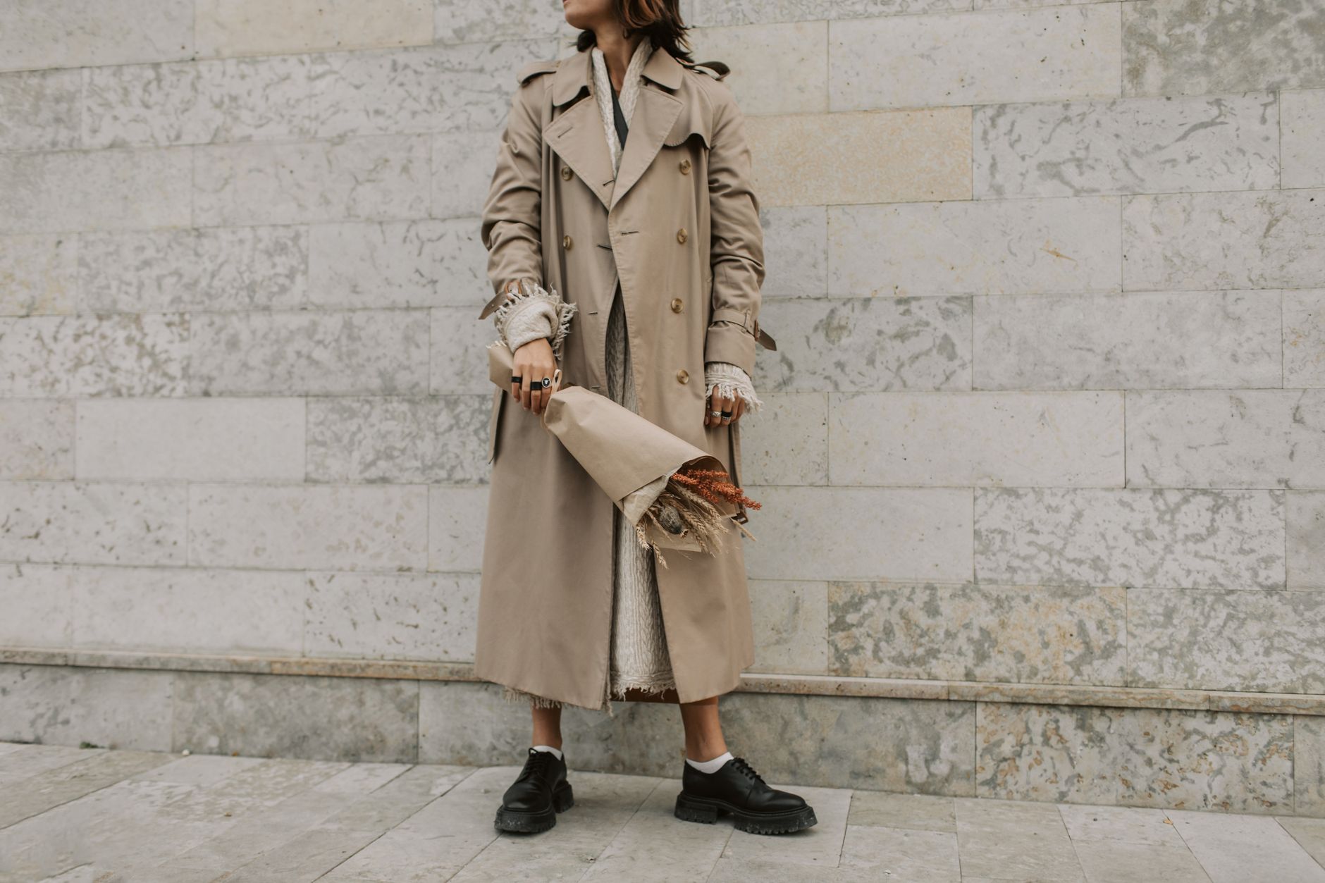 Woman in layered earth-tone clothing outdoors in autumn light