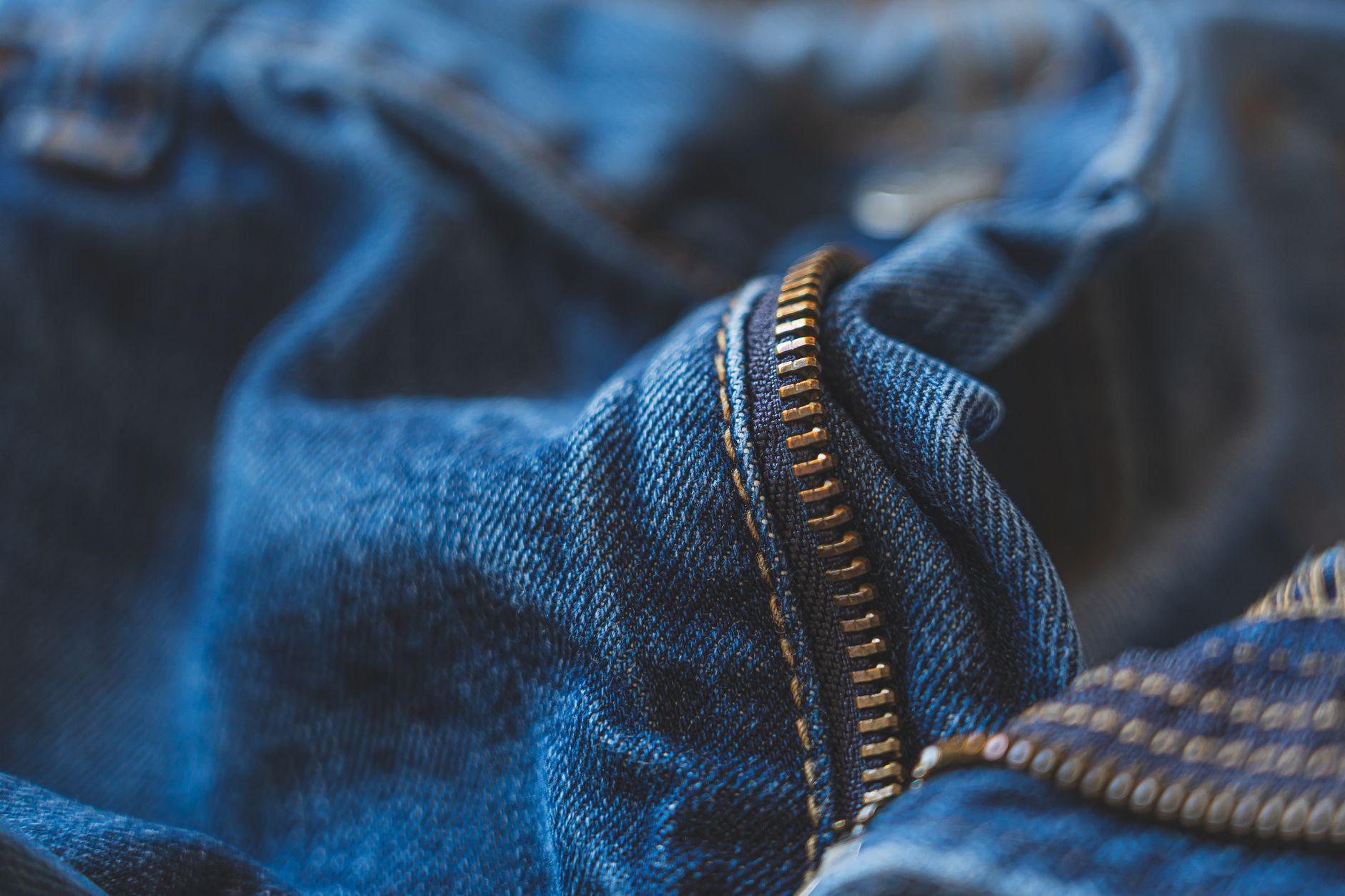 Close-up of cuffed boyfriend jeans hem with pointed-toe flats and minimal accessories