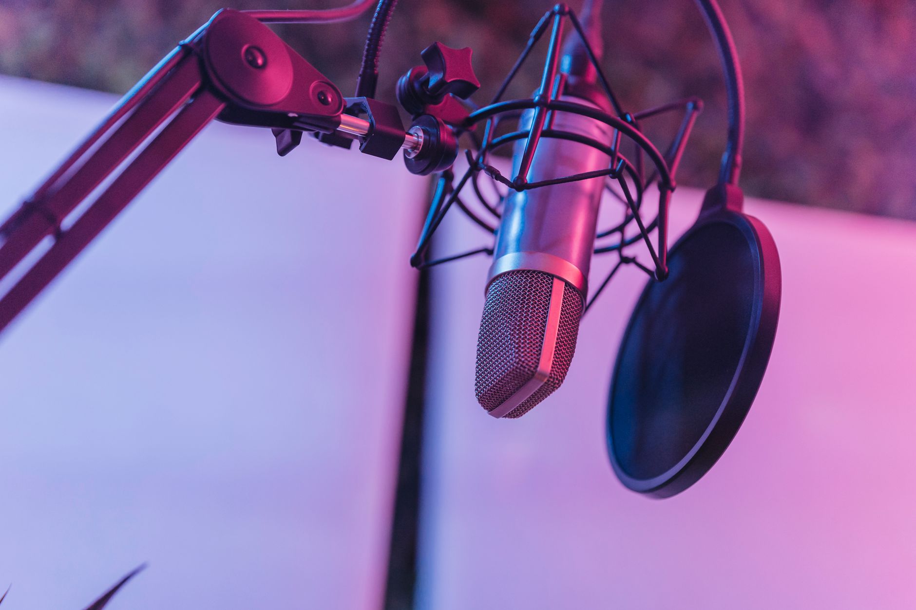 A microphone in a recording studio set up for a podcast interview