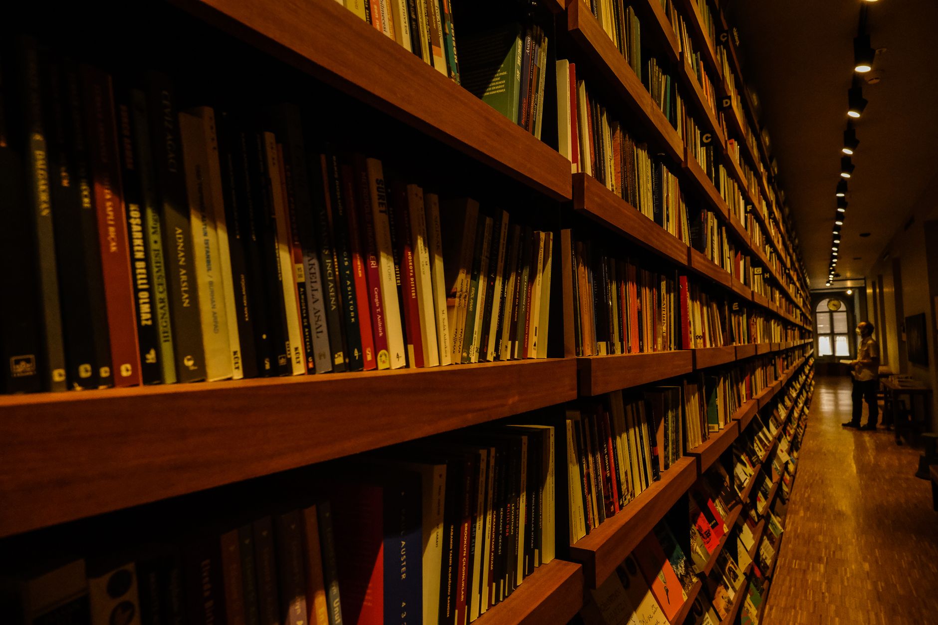 Romance novel spines lined up on a bookstore shelf