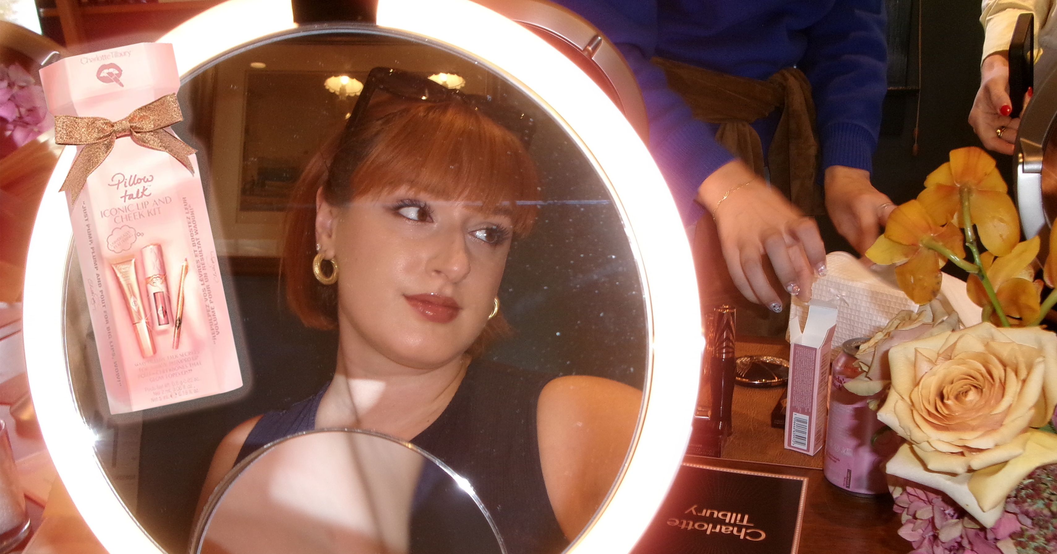 Assorted luxury makeup products arranged on a neutral surface
