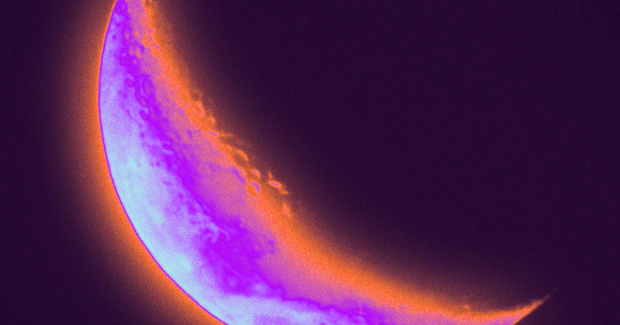 Dark Halloween night sky with a full moon partially obscured by clouds