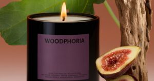 Fall Candles That Smell Like the Season, Not a Coffee Chain Warm autumn living room with candles and seasonal decor on a wooden table