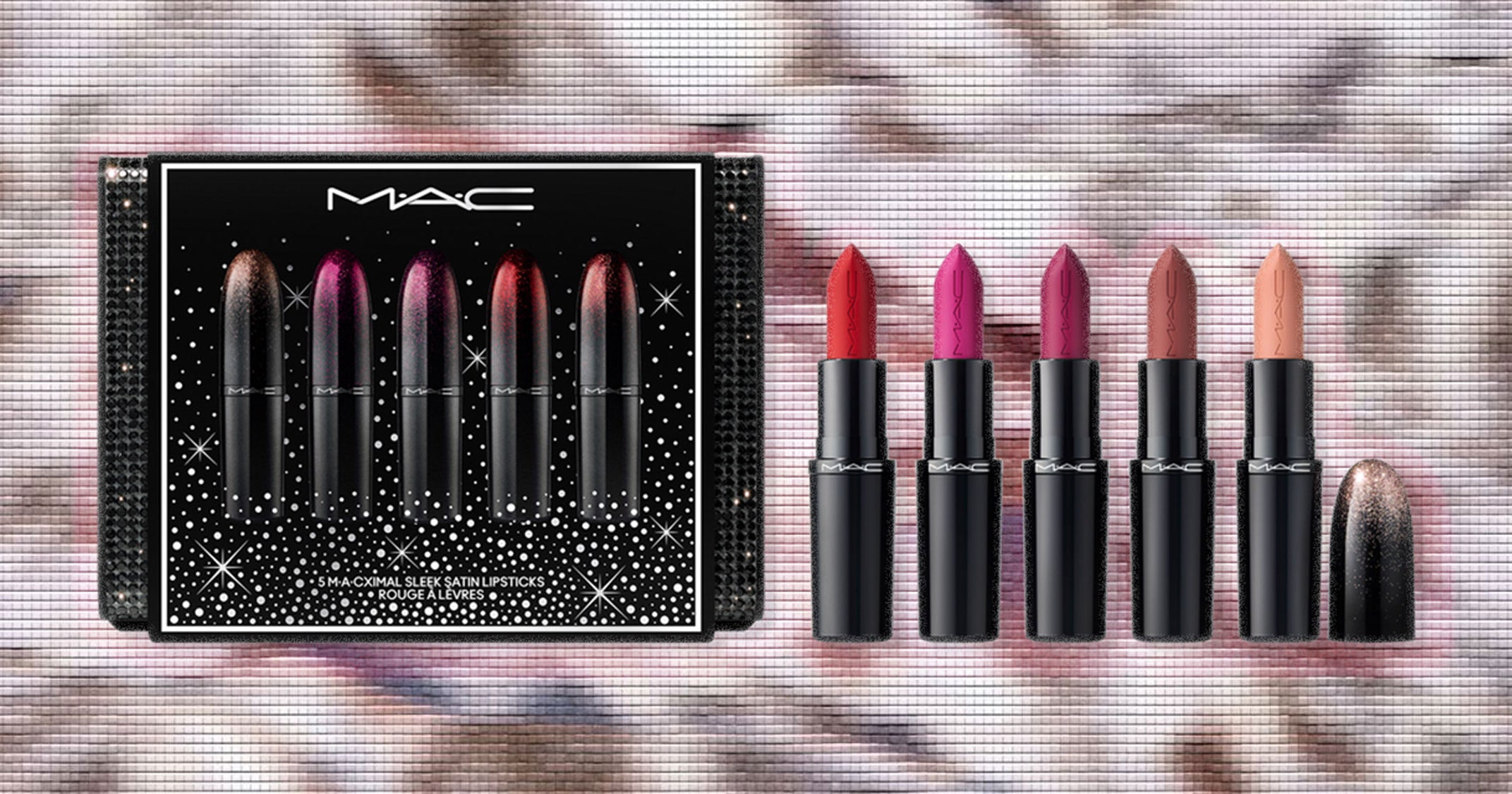 Assorted holiday beauty gift sets arranged on a surface with festive packaging